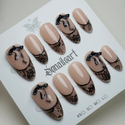 B4 | Sexy Lady press-on nails on display showing the full sheer nude and black lace nail art collection – Donailsart