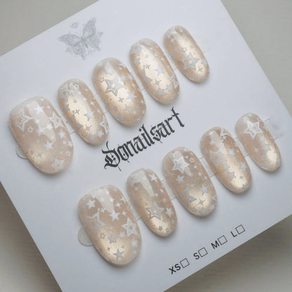 B5 | Ivory Lumen press-on nails on display showing the full sheer ivory and gold shimmer nail art collection – Donailsart