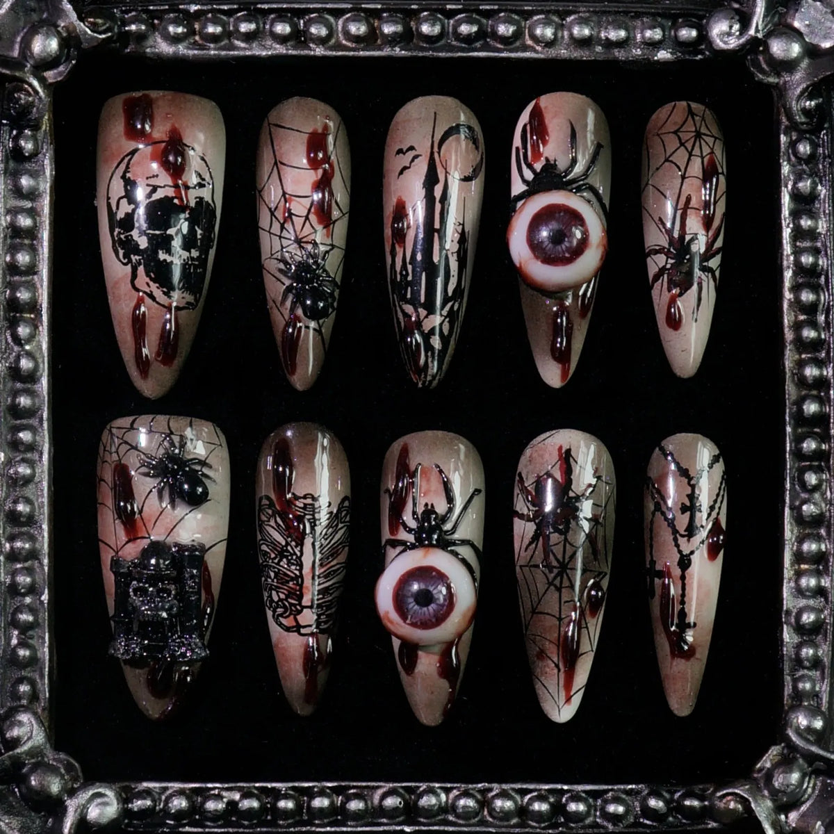 Creeping Gaze press-on nails: brown and black nails with skulls, barbed wire, spider webs and 3D eyeballs