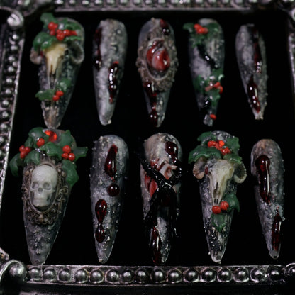 Baphomet x Christmas press-on nails, angled close-up of occult goat skulls and holly