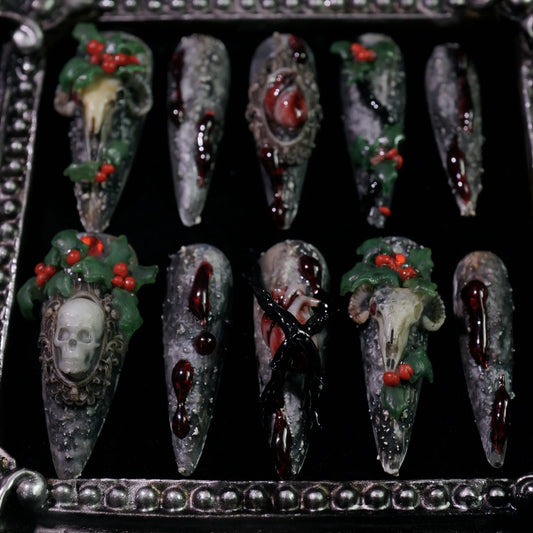Baphomet x Christmas press-on nails, angled close-up of occult goat skulls and holly