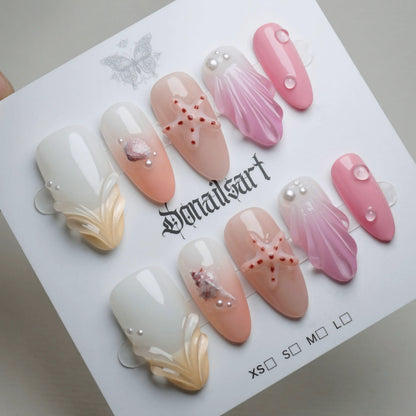 A27 | Pink Taffy Tide press-on nails on display showing the full peach pink beach nail art collection – Donailsart