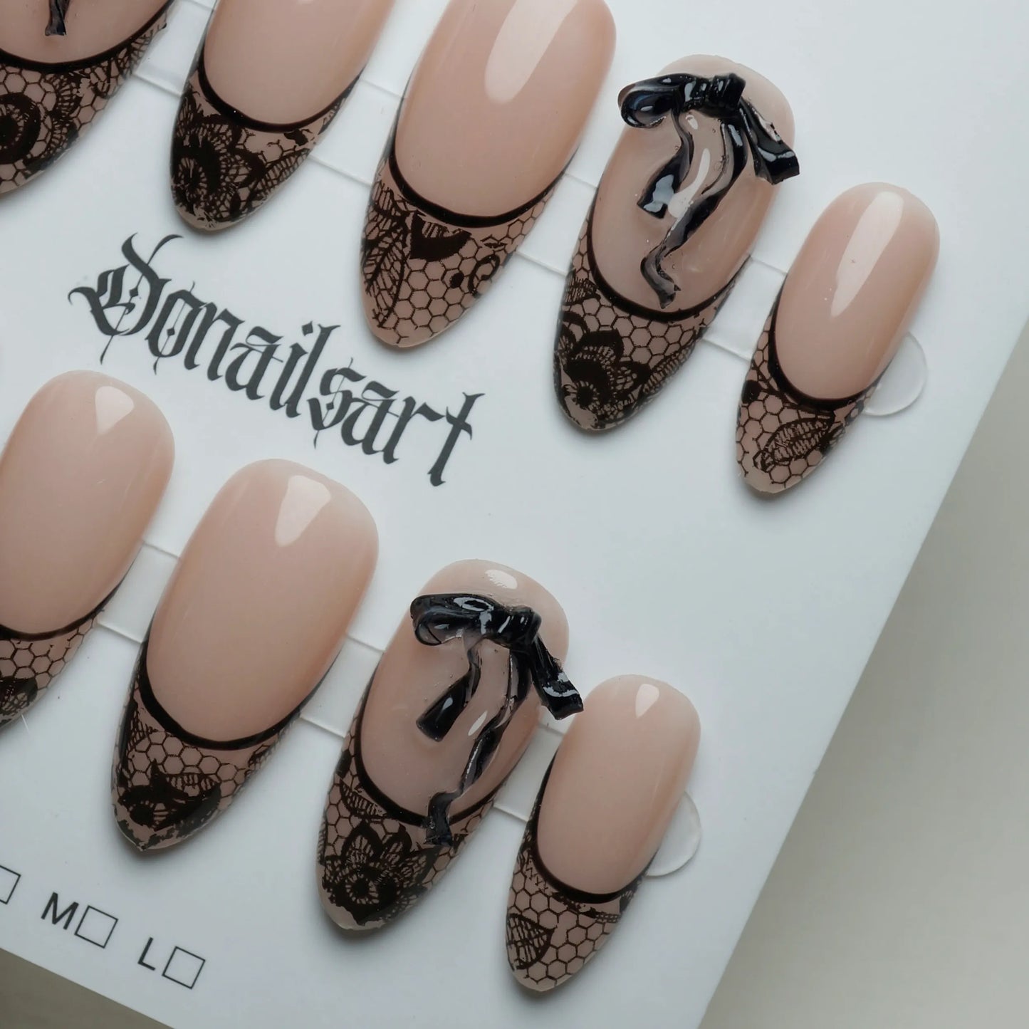 B4 | Sexy Lady nail art detail view featuring delicate black lace and ribbon overlay on nude press-on nails – Donailsart
