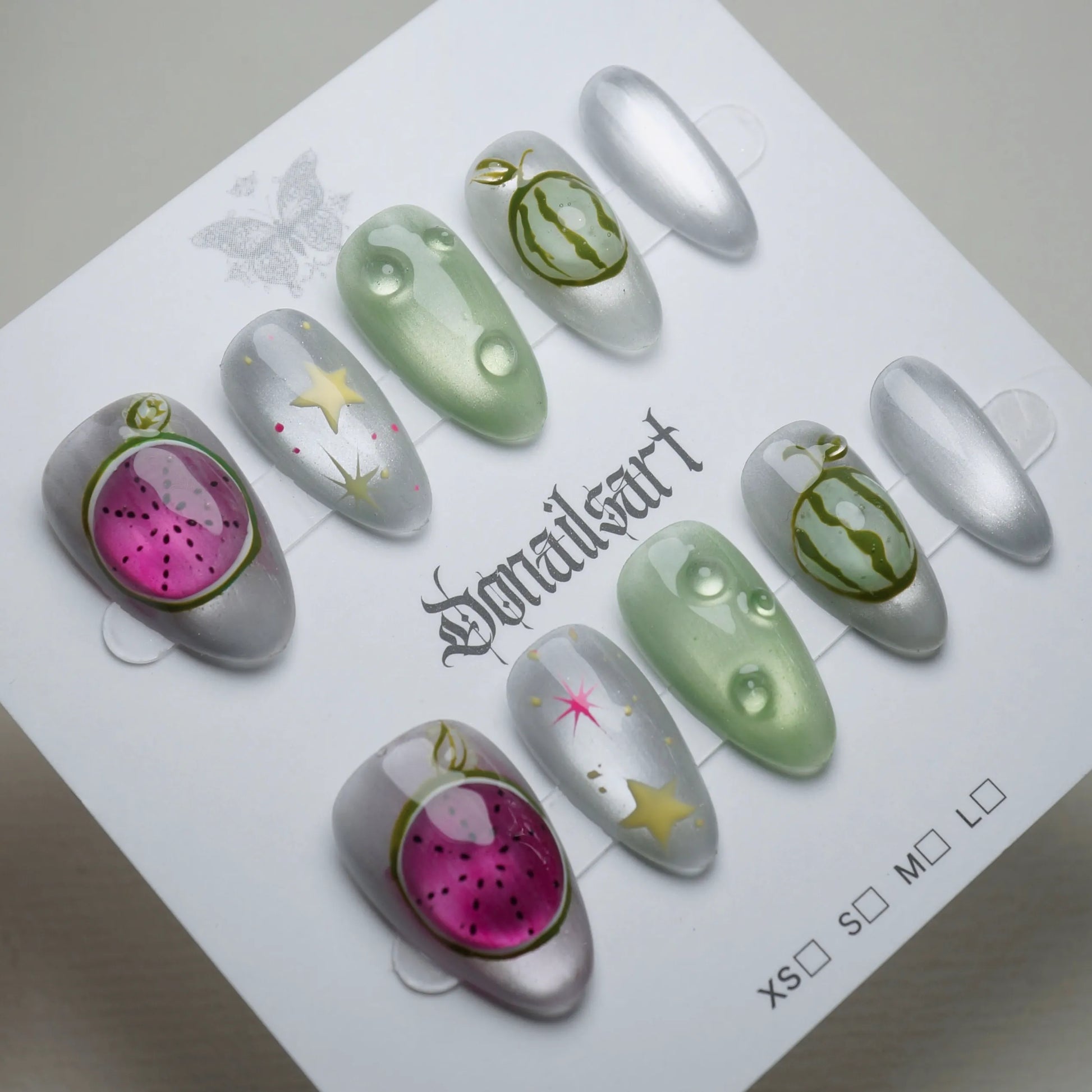 A26 | Melon Mirage press-on nails on display showing the full chrome silver and neon green fruit nail art collection – Donailsart