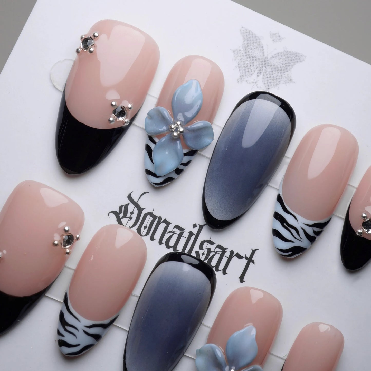 B1 | Velour Static close-up detail showing 3D floral accents and zebra print on soft nude and cool blue gradient nails – Donailsart