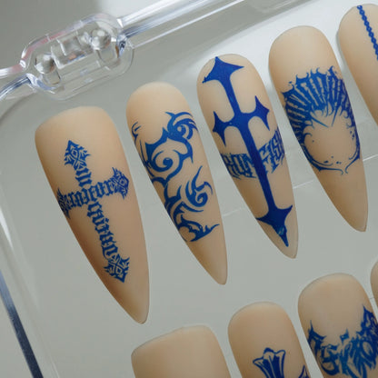 Blue Heresy close-up detail showing cobalt blue cross and distorted typography tattoo nail art on a nude base – Donailsart