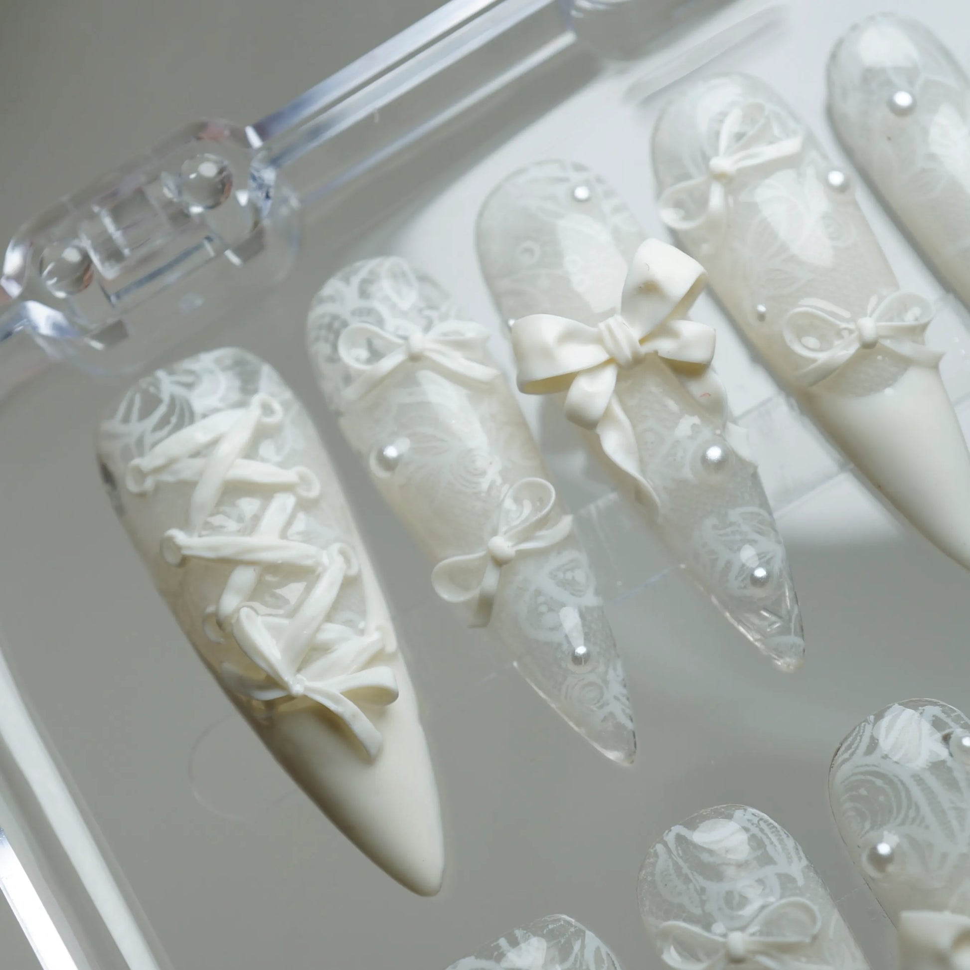 Ivory Keepsake close-up detail showing sculpted bow accent and delicate lace texture on a milky ivory nail – Donailsart