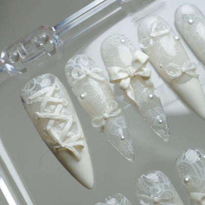 Ivory Keepsake close-up detail showing sculpted bow accent and delicate lace texture on a milky ivory nail – Donailsart