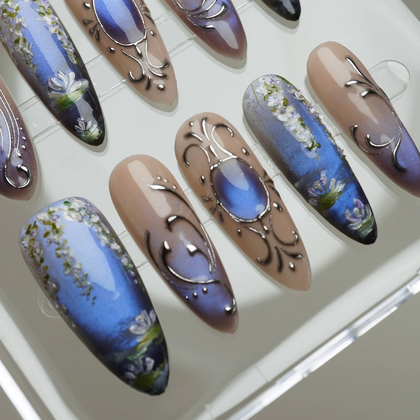 Velour Relic close-up detail showing fine chrome line details and soft floral accents on a blue-violet gradient nail – Donailsart