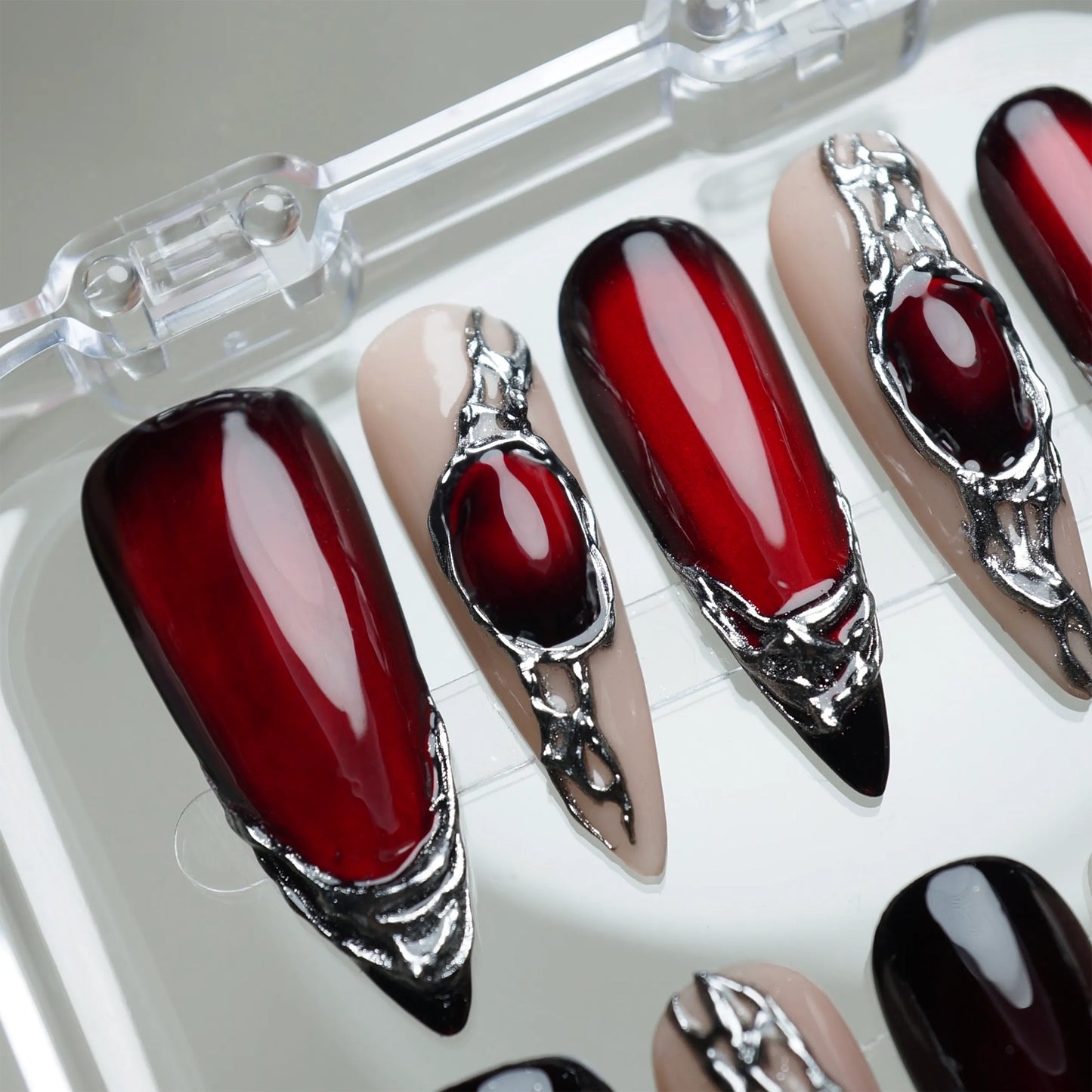Red Alloy press-on nail set product view with bold deep red and molten chrome statement nail art by Donailsart
