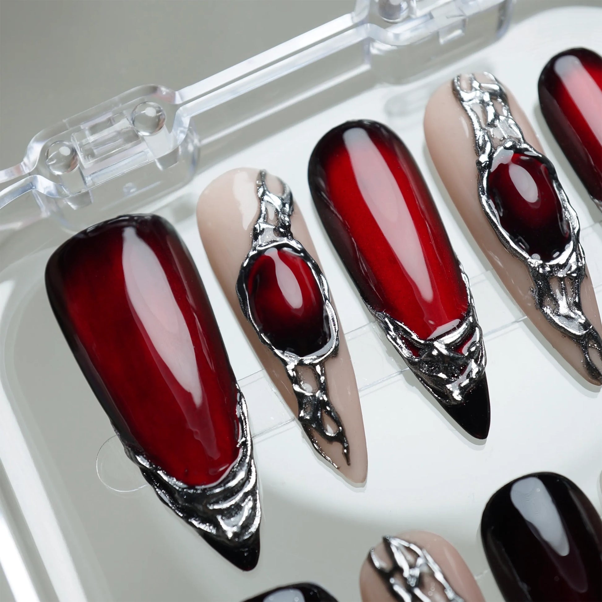 Red Alloy press-on nail set product view with bold deep red and molten chrome statement nail art by Donailsart