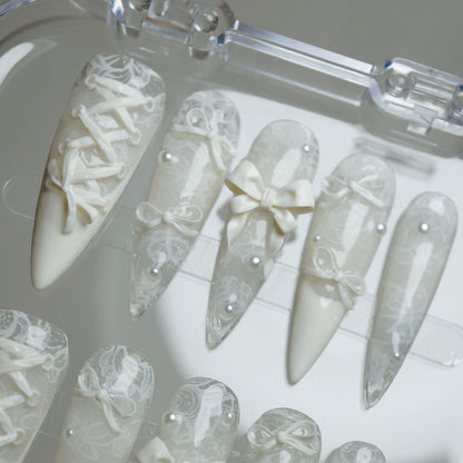 Ivory Keepsake press-on nails on display showing the full elegant lace and bow nail art collection – Donailsart