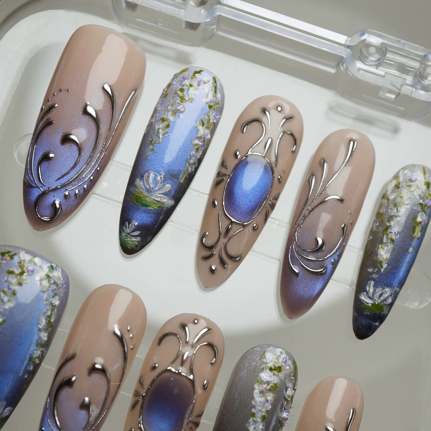 Velour Relic nail art detail view featuring antique ornamental chrome framing on muted nude and violet nails – Donailsart