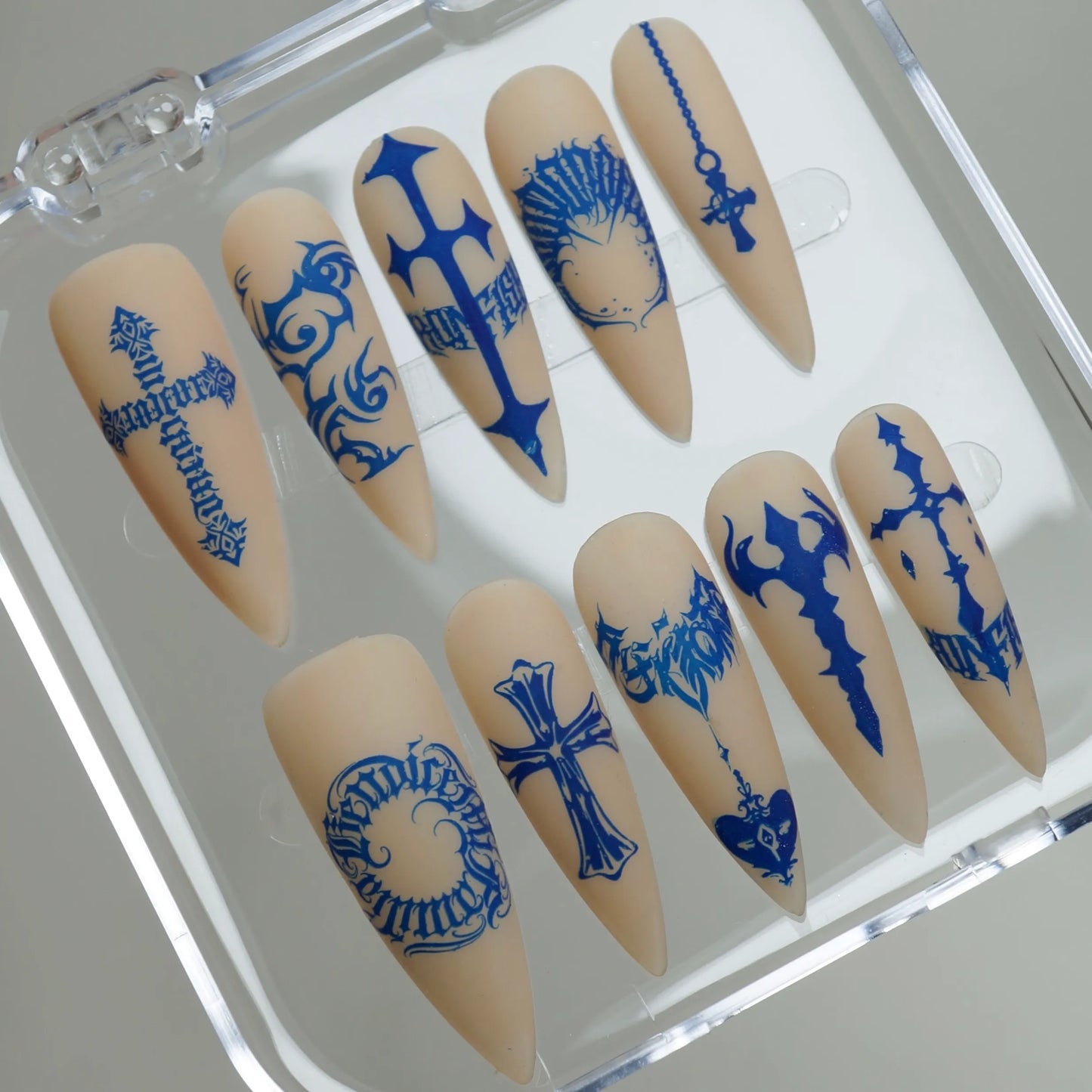 Blue Heresy press-on nails on display showing the full graphic symbol and cross nail art collection – Donailsart
