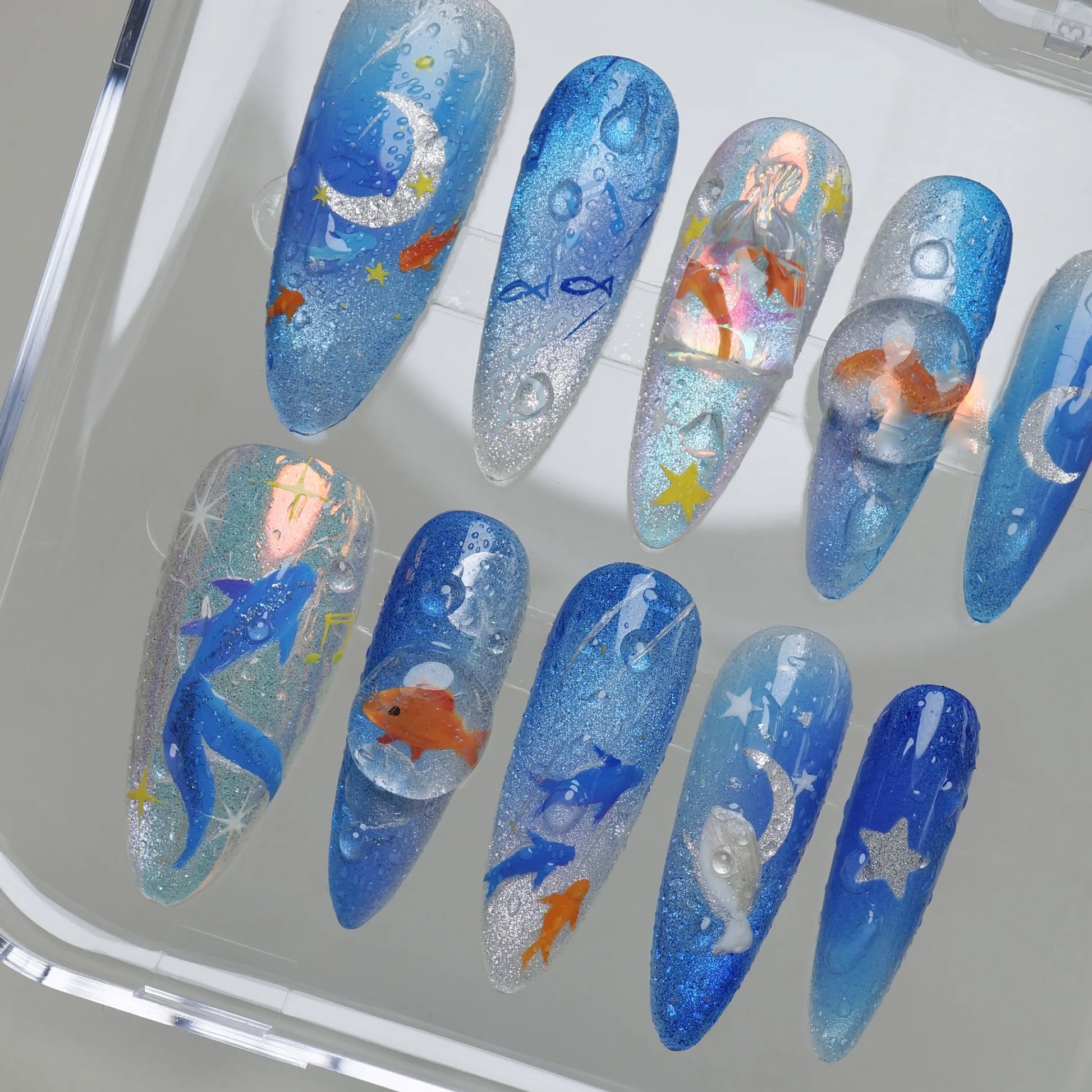 Starlit Aquarium press-on nail set product view with surreal moonlit aquarium nail art featuring goldfish and celestial details by Donailsart