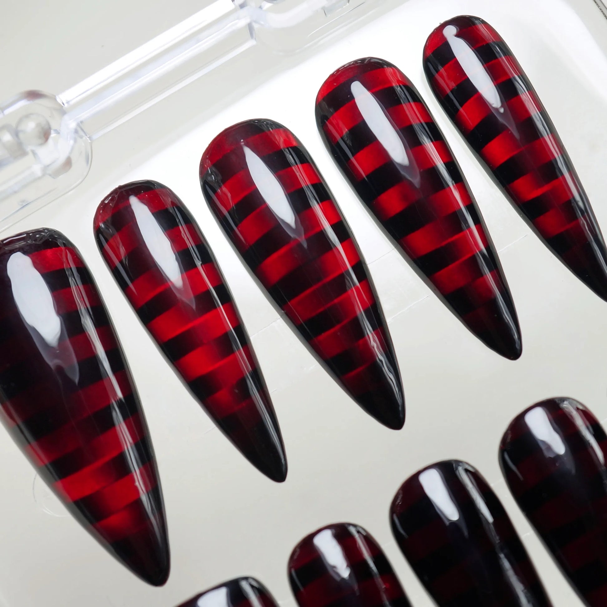Riot Grid nail art detail view featuring neon red plaid grid pattern under dark glass nail finish – Donailsart