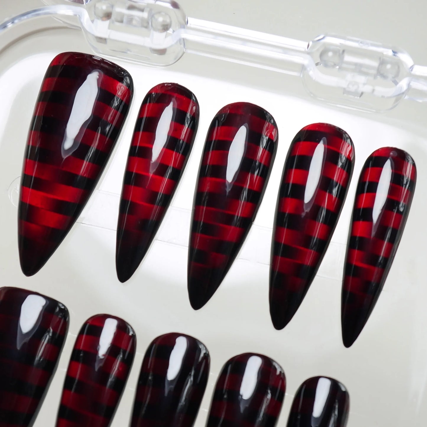 Riot Grid press-on nail set product view with high-voltage black and crimson grid nail art by Donailsart
