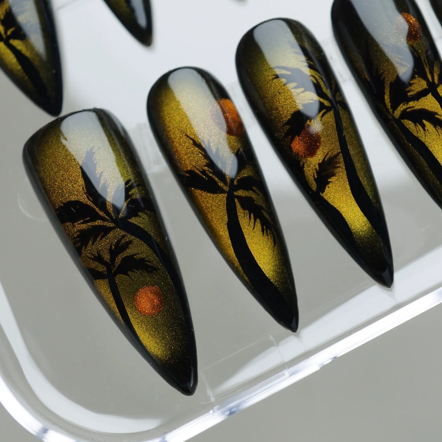 Island Sunrise close-up detail showing cat-eye shimmer effect with golden sunrise tones and black palm tree nail art – Donailsart