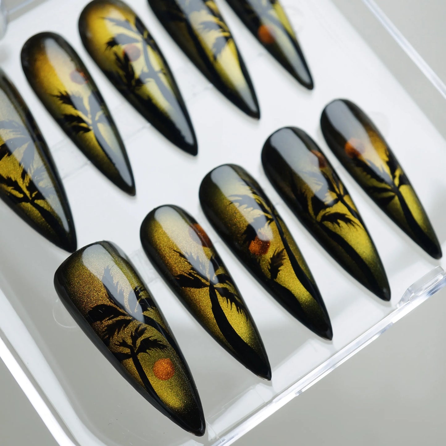 Island Sunrise nail art detail view of molten gold reflective finish with black silhouette palm tree designs – Donailsart