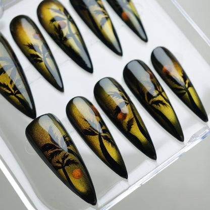 Island Sunrise nail art detail view of molten gold reflective finish with black silhouette palm tree designs – Donailsart