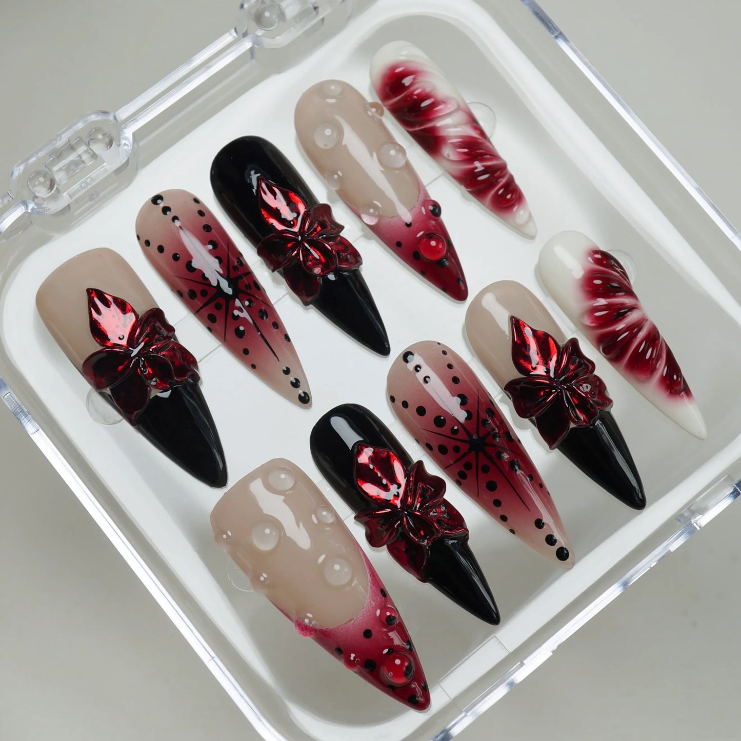 Rouge Relic press-on nails on display showing the full dark romantic floral nail art collection – Donailsart