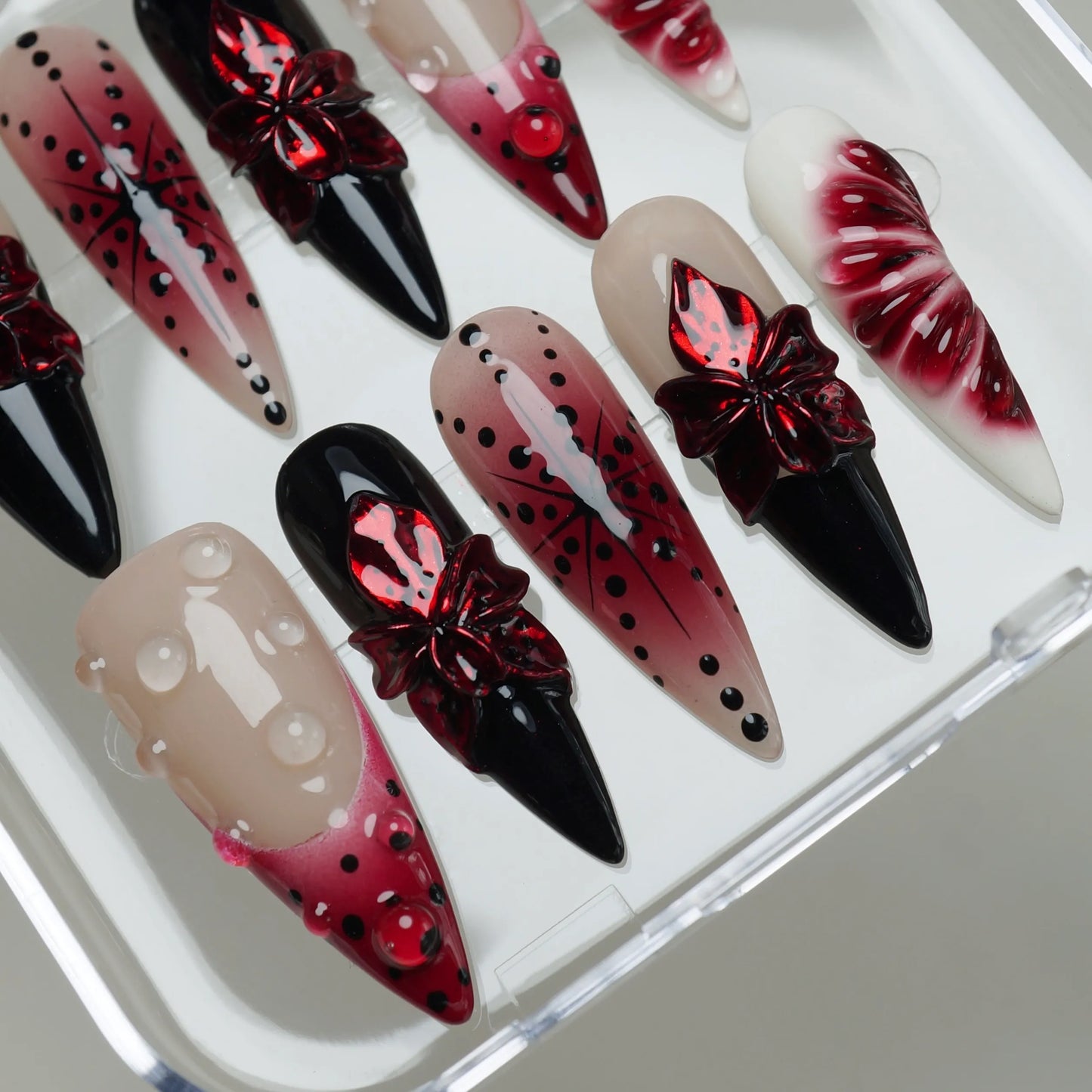 Rouge Relic close-up detail showing sculpted flower accents and glossy gel droplets on deep rouge and nude nails – Donailsart
