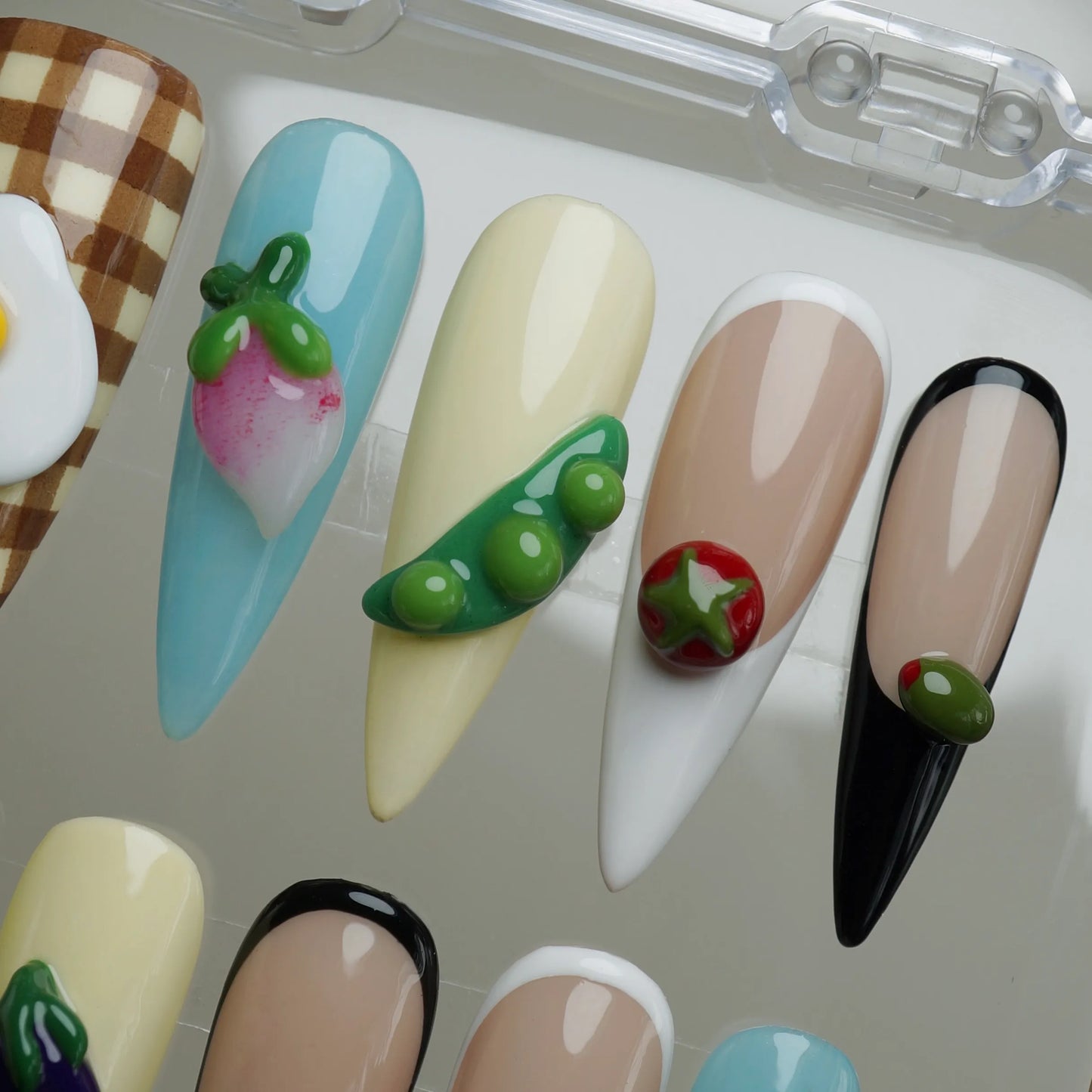 Picnic Plate press-on nail set product view with funny cute food-themed nail art featuring gingham and garden vegetables by Donailsart