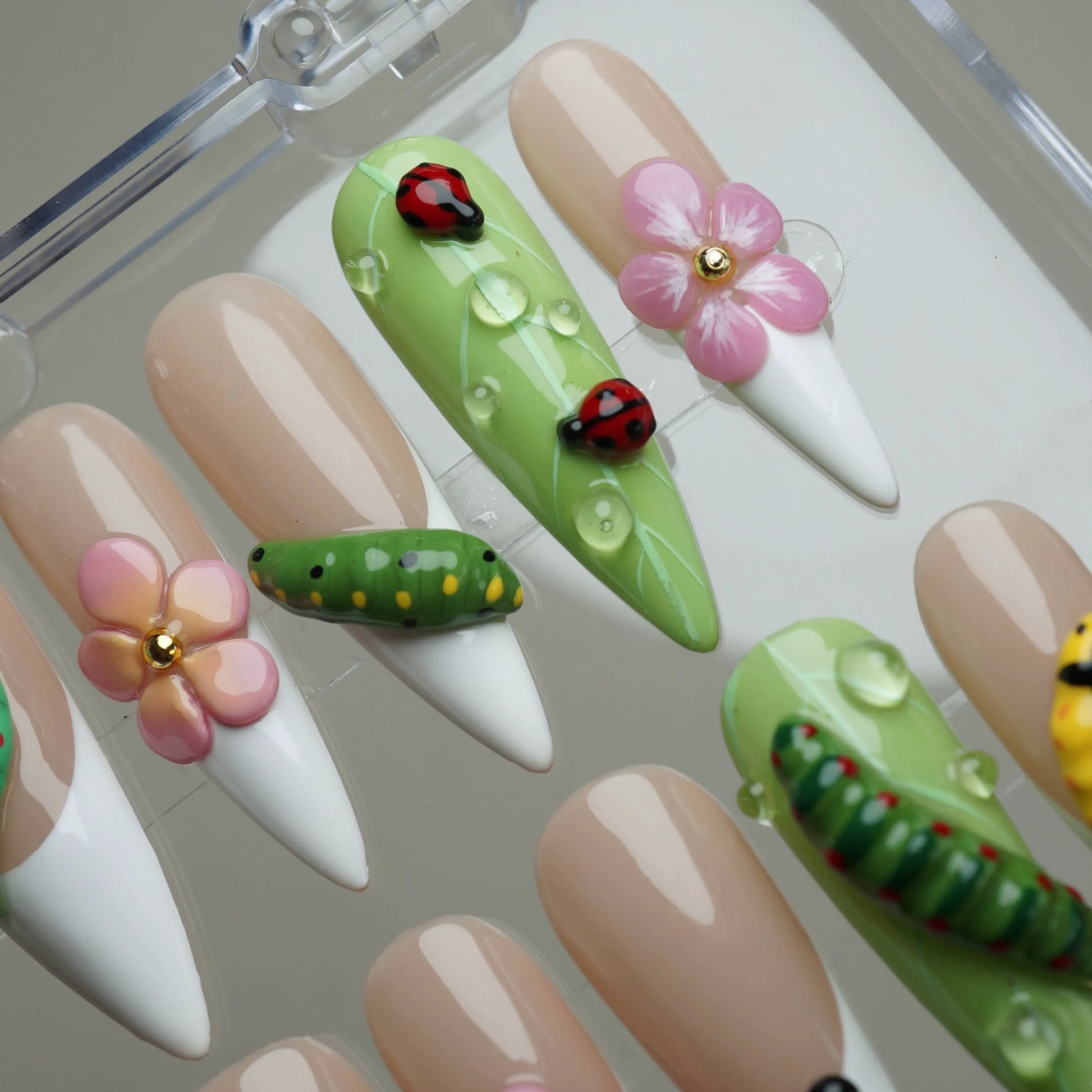 Mini Bug press-on nail set product view with cute spring garden insect and floral nail art by Donailsart