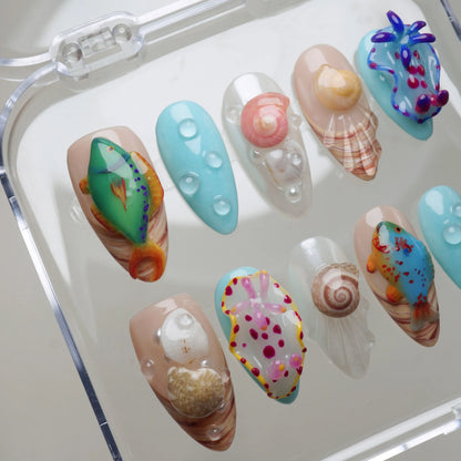 Colorful nail art designs on a clear stand with various patterns and colors.