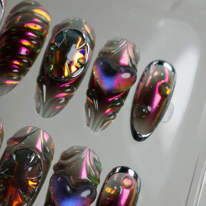 Futuristic press-on nails from Donailsart with multidimensional 3D designs, reflective heart motifs, and gemstone-inspired textures