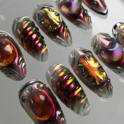 Donailsart press-on nails with black chrome armor style, fiery orange stones, and holographic finishes