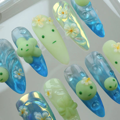 Unique smiski nails combining adorable character art with oceanic themes and floral embellishments