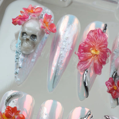Fantasy-inspired summer nails art with pearl chrome base, sculpted flowers, mystical silver charms, and surreal motifs