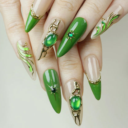 Close-up of hands with green nail art and decorative elements on a neutral background