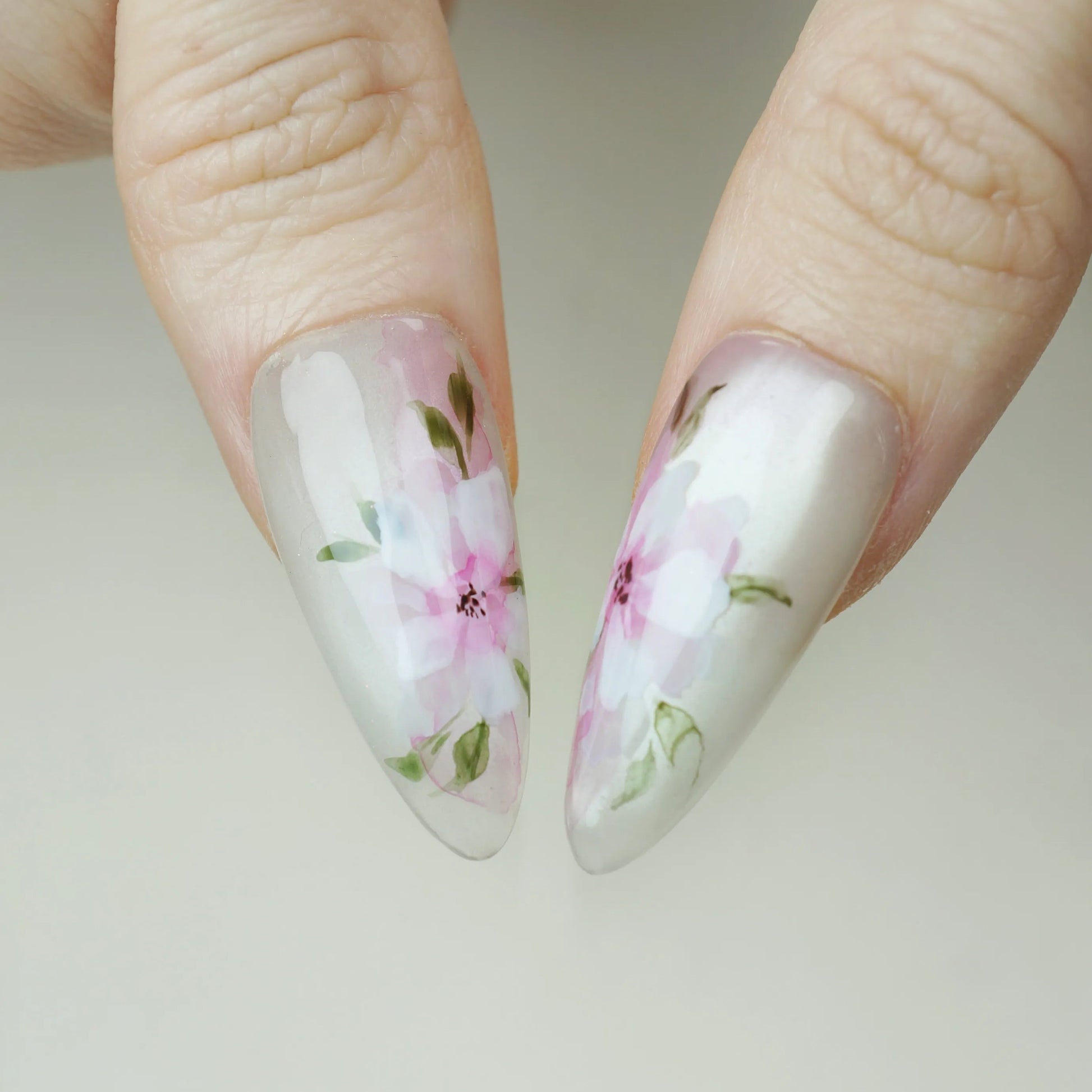 Petal Drift close-up detail showing hand-painted blush pink floral and muted mauve accents on a translucent pearl nail – Donailsart