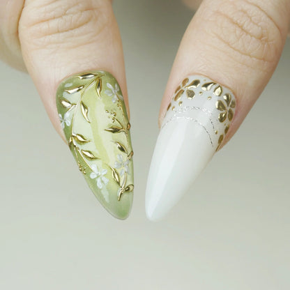 Laurel Veil close-up detail showing sculpted gold botanical lines and pearl accents on a muted sage green nail – Donailsart