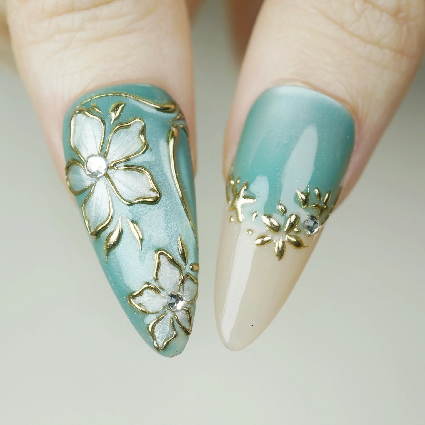 Tidal Heirloom close-up detail showing antique gold floral detailing and crystal accents on a seafoam blue nail – Donailsart