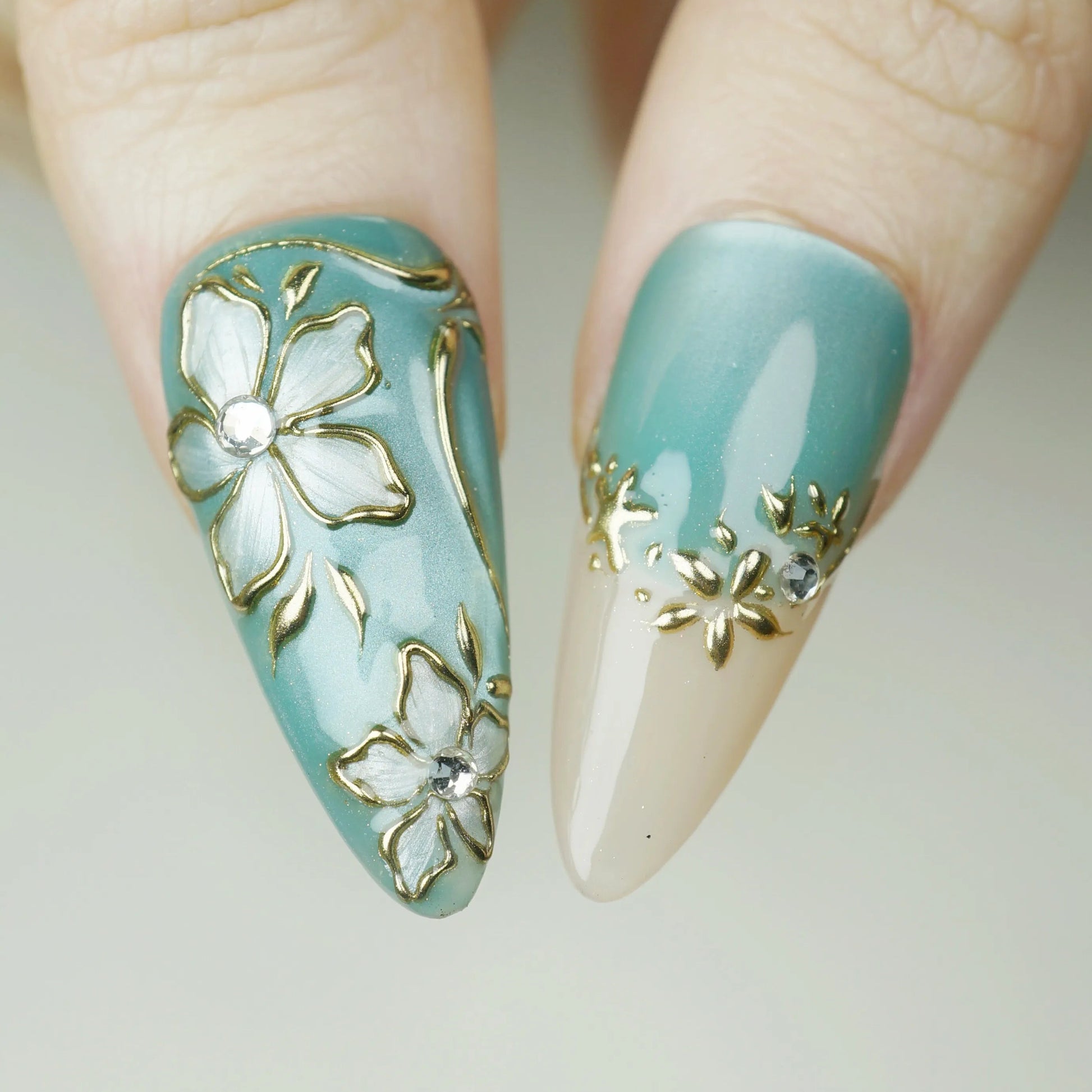 Tidal Heirloom close-up detail showing antique gold floral detailing and crystal accents on a seafoam blue nail – Donailsart