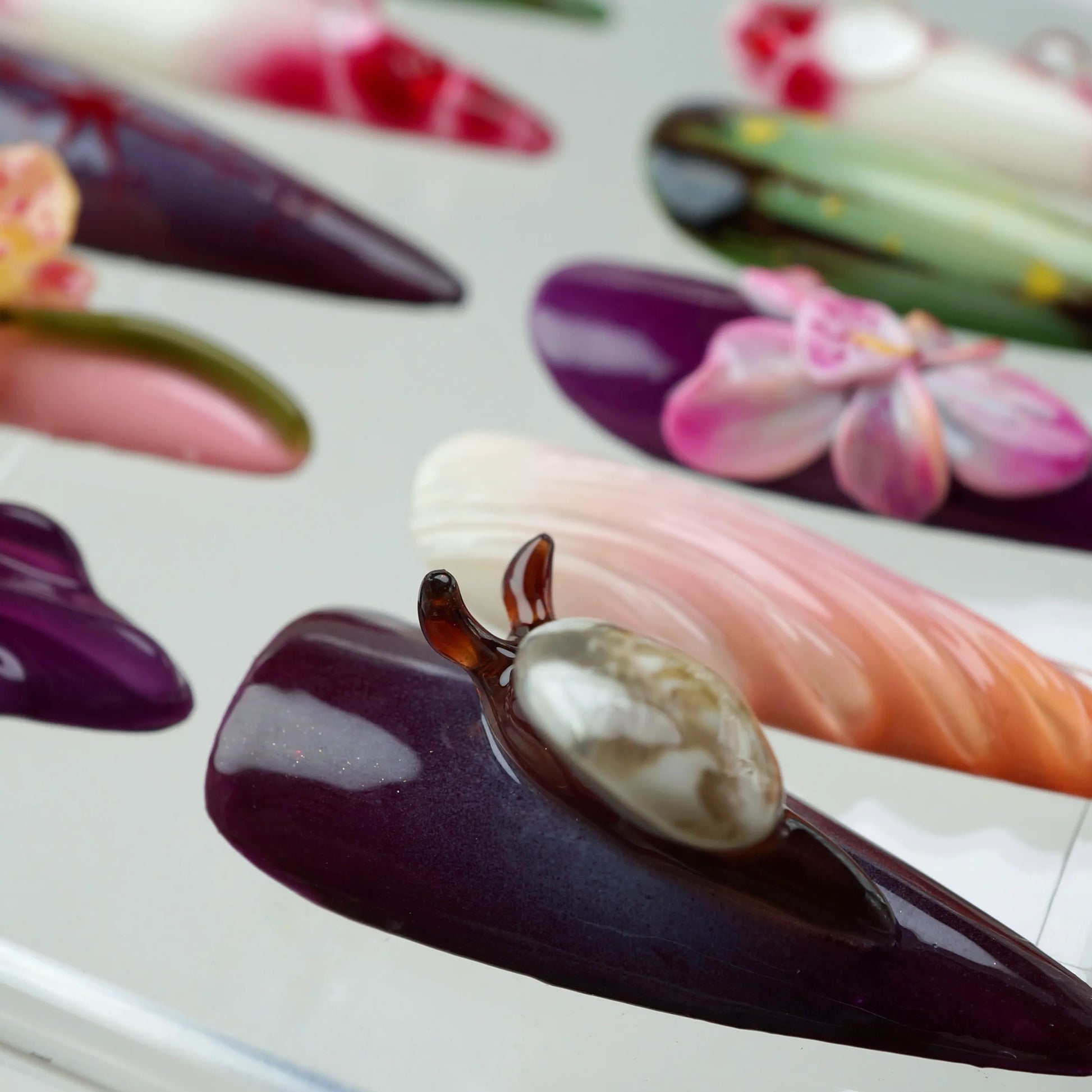 Unique flower design nails blending earthy tones with bold textures, showcasing floral art and nature-inspired detailing