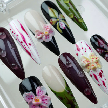 Unique flower design nails with a mix of natural and artistic patterns, including orchids, lilies, and glossy finishes