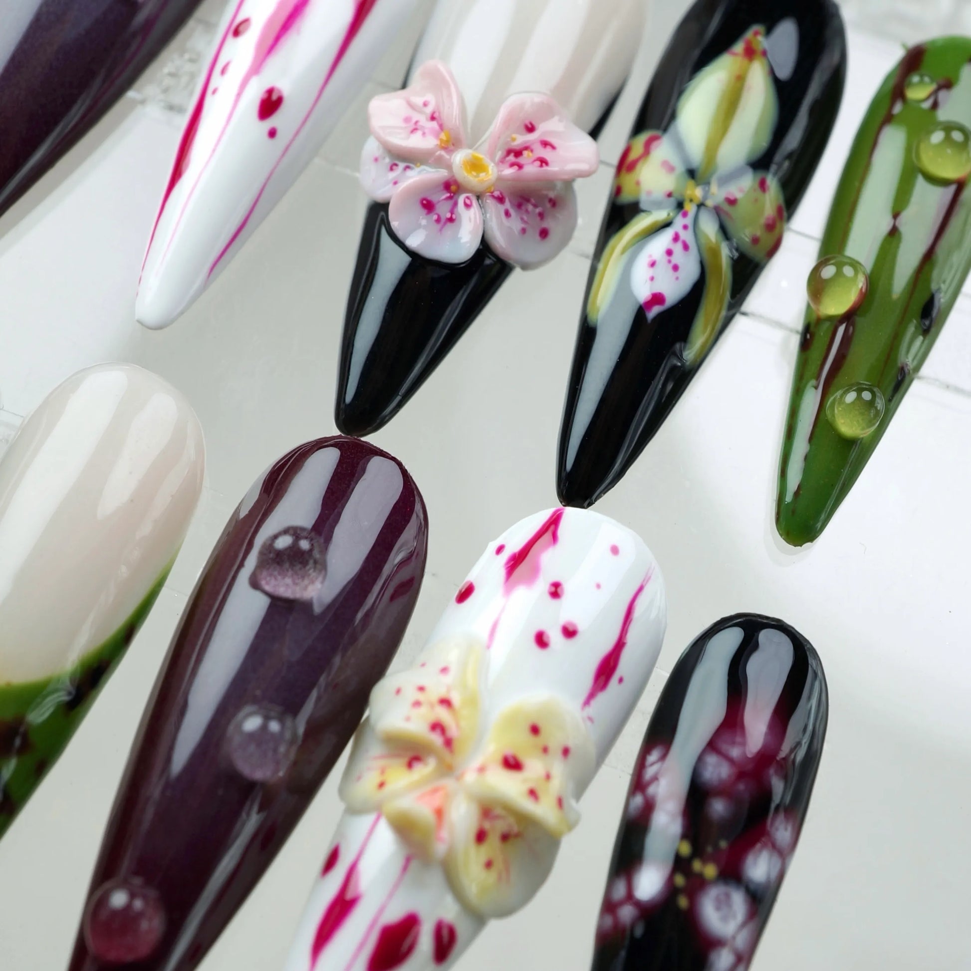 Dark romantic flower design nails with burgundy, black, and ivory tones, decorated with blooming florals and raindrop details