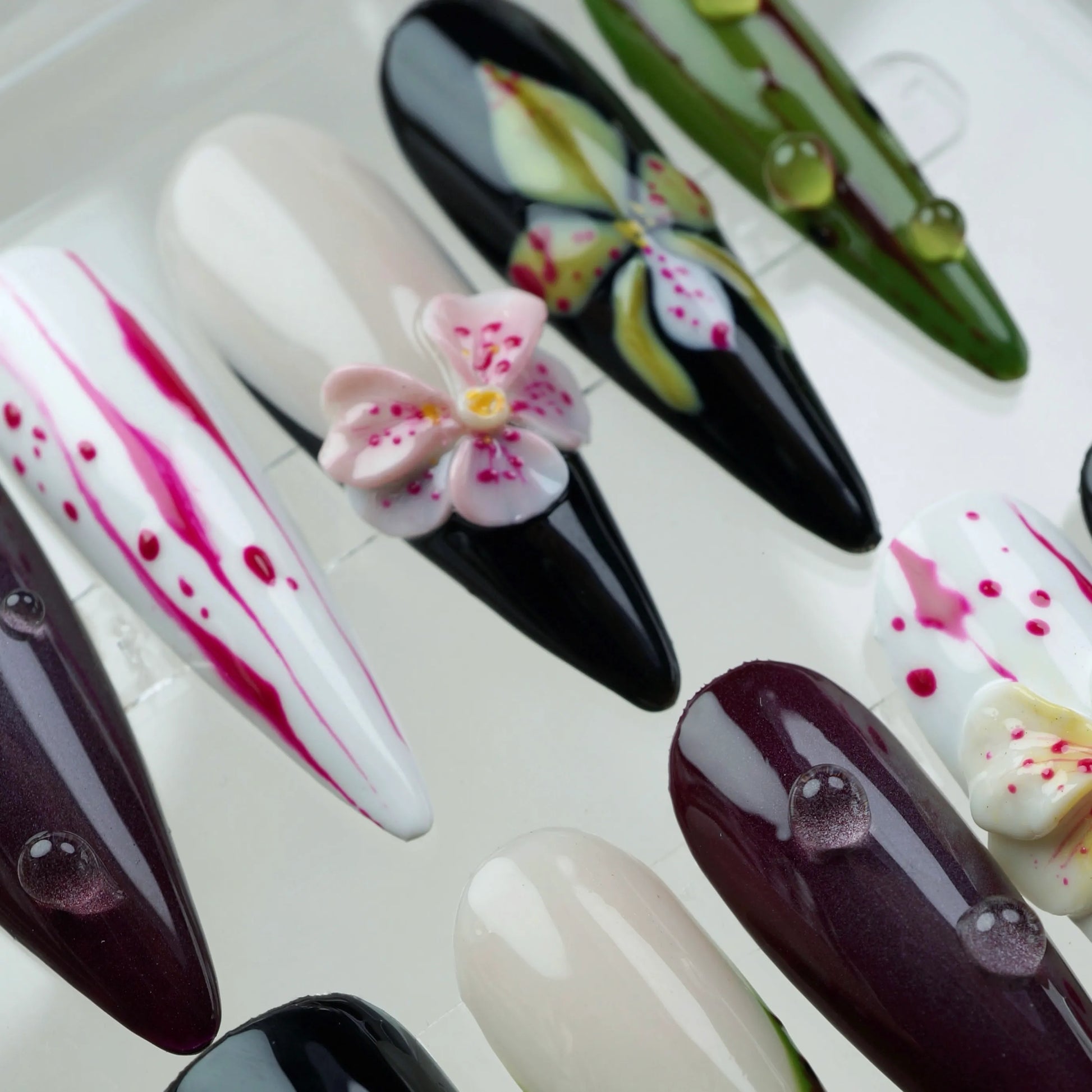 Creative flower design nails with a moody garden vibe, combining hand-painted flower art and 3D blossoms for texture