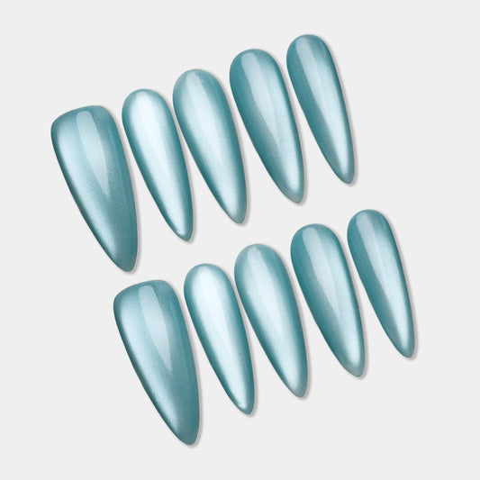 Set of light blue nail extensions on a light gray background