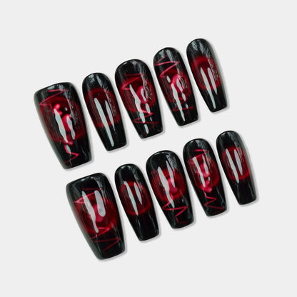 Set of black and red nail wraps on a light gray background
