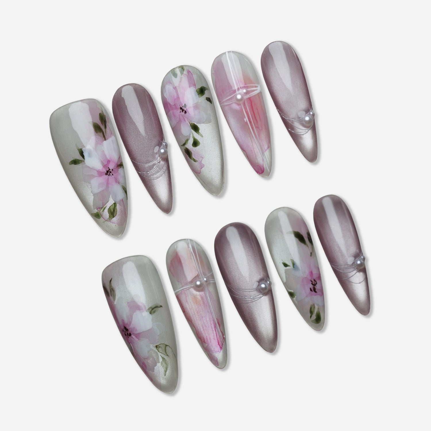 Petal Drift press-on nail set by Donailsart – translucent pearl base nails with blush pink floral artwork, muted mauve accents, and hand-painted botanical details