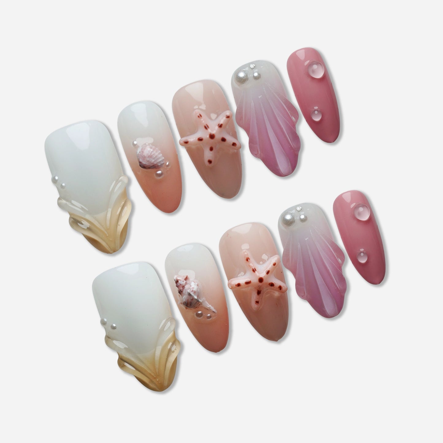 A27 | Pink Taffy Tide press-on nail set by Donailsart – creamy white and peach nails with glossy pink tones, sculpted shells, and tiny starfish accents