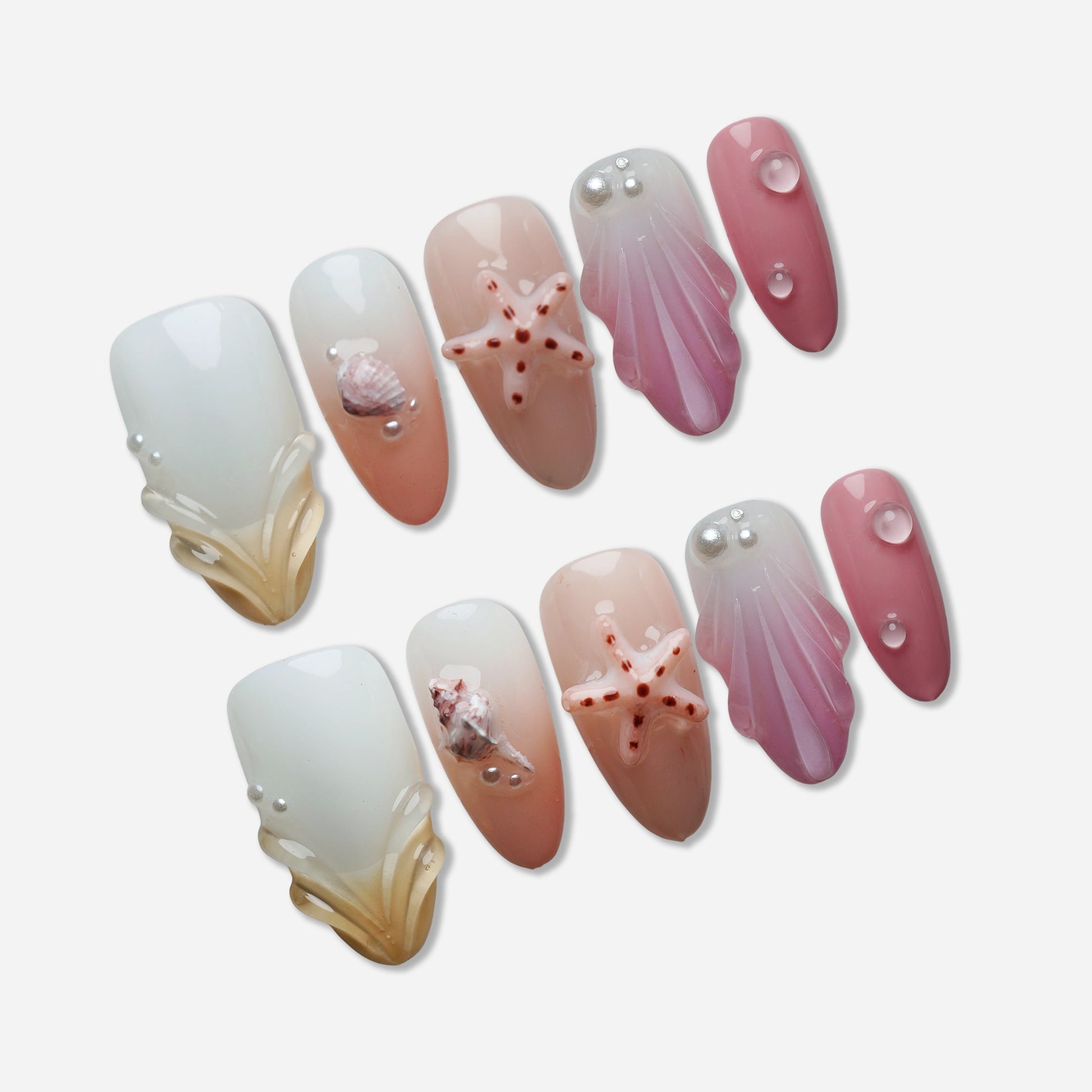 A27 | Pink Taffy Tide press-on nail set by Donailsart – creamy white and peach nails with glossy pink tones, sculpted shells, and tiny starfish accents