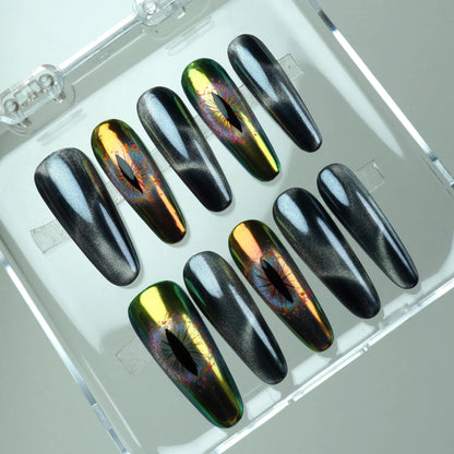 Press-on nails featuring black cat-eye magnetic shimmer and holographic reptile-eye designs in green and gold chrome by Donailsart

