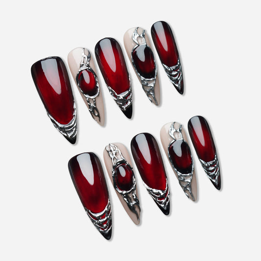 Red Alloy press-on nail set by Donailsart – deep crimson nails sealed under a glass-like surface with molten chrome metal frames and dark wine to liquid fire color shift