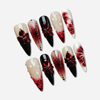 Rouge Relic press-on nail set by Donailsart – nude and deep rouge jelly nails with glossy black contrast, sculpted floral accents, and clear gel droplets